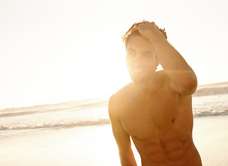 Image showing Man, smile and freedom at the beach on a holiday and summer vacation outdoor with travel. Happy, sea and male person from California by the ocean with confidence and lens flare from trip and journey