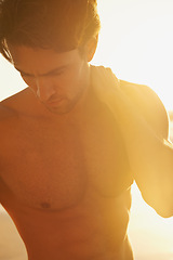 Image showing Man, shirtless and travel to beach at sunset, confidence and tourist at sea on summer holiday. Male person, topless and outdoor adventure for fun, calm ocean and peaceful environment in nature