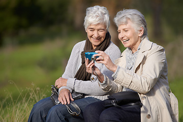 Image showing Senior woman, outdoor and camera with pictures, happy and photography with memories in nature or elderly. Technology, bonding and chatting with friend, funny and laughing together in retirement