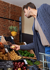 Image showing Potato, food and man shopping at a supermarket for grocery promotions, sale or discounts deal. Check, fresh or customer buying groceries for healthy nutrition, organic vegetables or diet with choice