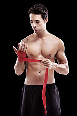 Image showing Man, hand wrap and fitness with boxer in a studio ready for boxing training and workout. Body, athlete and male fighter from Brazil with exercise, sport and wellness for battle with black background