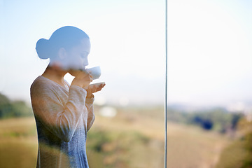 Image showing Woman, coffee with window and balcony outdoor, drink warm beverage with morning routine and zen in nature. Peace, calm and espresso for caffeine, glass and tea cup in countryside for leisure