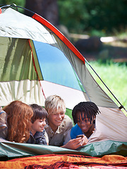 Image showing Friends, camping and happy of children in tent for resting, relaxing and bonding with cellphone. Travel gear, smile and young girls and boys for adventure on holiday, vacation and weekend outdoors