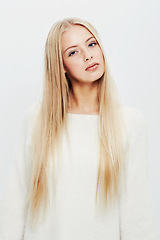 Image showing Woman, portrait and fashion for natural beauty, style or haircare on a white studio background. Face of young female person, blonde or attractive model in casual clothing with makeup and cosmetics