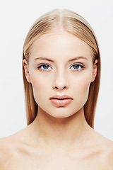 Image showing Portrait, woman and beauty or cosmetic in studio, confident and cosmetology for facial skin treatment. Young model, face and shine in self care or blonde hair and organic makeup by white background