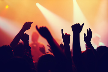Image showing Party, concert and hands of people in audience or crowd with energy for dance event at night. Music, light and festival with group of fans at rock or disco performance on stage for celebration