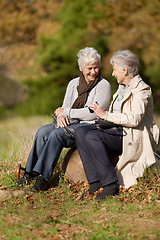 Image showing Senior women, laughing or conversation in nature for travel, together or bonding on retirement in outdoor. Elderly friends, smile or communication on vacation in countryside, care or social on rock