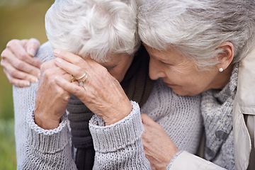 Image showing Senior women, friends and crying in nature, embrace and grief in outdoor environment. Elderly people, garden and comfort in peaceful park for affection, sadness and hugging for care in retirement