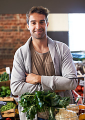 Image showing Portrait, basket or happy man shopping in supermarket for grocery promotions, sale or discounts deal. Arms crossed, smile or customer buying groceries for healthy food, organic vegetables or spinach