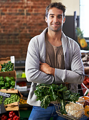 Image showing Portrait, healthy food or happy man shopping in supermarket for grocery sale or discounts deal. Arms crossed, smile or customer buying fresh produce for diet nutrition, organic vegetables or spinach