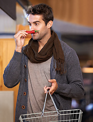 Image showing Pepper, smell or man shopping at a supermarket for grocery promotions, sale or discounts deal. Chilli, check or customer buying groceries for healthy nutrition, organic vegetables or diet for choice