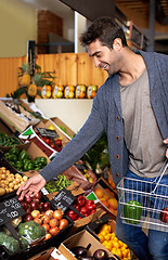 Image showing Vegetables, food or happy man shopping at a supermarket for grocery promotions, sale or discounts deal. Check, choice or customer buying groceries for healthy nutrition, fresh organic produce or diet