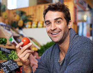 Image showing Tomato, portrait or happy man shopping at a supermarket for grocery promotions, sale or discounts deal. Smile, retail or customer buying groceries for healthy nutrition, organic vegetables or food