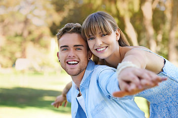 Image showing Portrait, piggy back and couple in a park, love and happiness with marriage and romance. Face, man carrying woman or outdoor with fun or relationship with care or trust with smile or bonding together