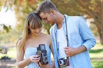 Image showing Retro camera, nature or couple check results of vintage photography, photo memory or creative photoshoot. Antique equipment, tourist or nature photographer looking at garden picture for media project