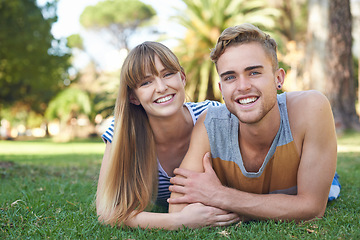 Image showing Couple, smile in portrait and relax on grass in park, love and commitment in healthy relationship with picnic outdoor. Happy, care and trust with people in nature or public garden for romantic date