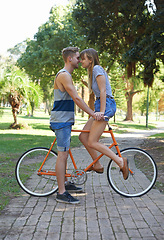 Image showing Romance, love and couple on bicycle journey, outdoor wellness and romantic date in nature. Travel, care and people cycling for bonding activity, transportation and connect with partner on bike ride