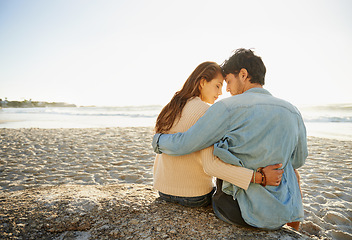 Image showing Beach sunset, hug and relax couple with love, support and relationship security on summer holiday in Portugal. Mockup space, forehead touch and back of partner, soulmate or people embrace on date