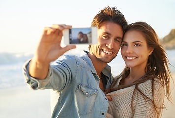 Image showing Couple, selfie and hug with smile at beach for memory on vacation with care, love and bonding in summer. Man, woman and tropical holiday with photography, profile picture and post on social network