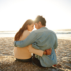 Image showing Beach sunset, hug and couple relax with love, support and relationship security on summer holiday in Greece. Embrace, forehead touch and back of marriage partner, soulmate or people bonding on date