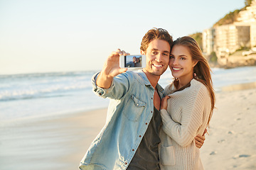 Image showing Couple, selfie and happy for hug by ocean for memory on vacation with care, love and bonding in summer. Man, woman and nature for holiday with photography, profile picture and beach on social network