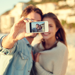 Image showing Couple, selfie and smile for hug by ocean for memory on vacation with care, love and tropical beach. Man, woman and smartphone screen for photography, profile picture and app by sea on social media