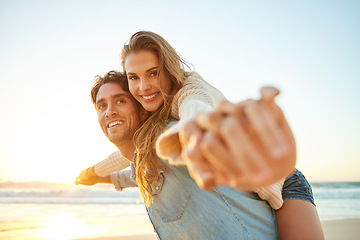 Image showing Man, woman and piggy back at beach sunset or adventure summer for travel, bonding or marriage. Happy couple, embrace and weekend love for dating tourism or nature vacation, environment or holiday