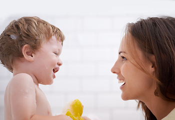 Image showing Happy, rubber duck and mother bathing baby for hygiene, body care and health at family home. Smile, toy and young mom washing and bonding with infant, kid or child toddler in bathroom of house.