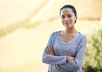 Image showing Woman, arms crossed and portrait outdoor, smile with calm and wellness in countryside for travel. Adventure, peace and happy in nature with confidence, mockup space and environment with positivity