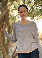 Image showing Woman, tree and eyes closed for peace in forest, travel and think about life, mindfulness and sun. Nature park in Brazil, calm outdoor for zen and dream in environment with tranquility and fresh air