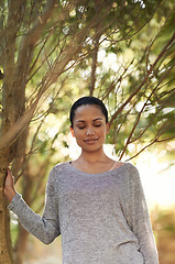 Image showing Woman, tree and eyes closed for peace in woods, travel and thinking about life, mindfulness and sunshine. Forest, nature and calm outdoor, zen and dream in environment with tranquility and fresh air