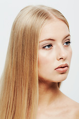 Image showing Young, model and beauty or cosmetic in studio, confident and cosmetology for facial skin treatment in wellness. Woman, glow or shine in self care or blonde hair or organic makeup by white background