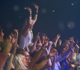 Image showing Concert, audience and music with happy woman in group at dj, band and festival event at a stage with lights. Rock show, dance and party with excited crowd with rave, techno and entertainment at venue
