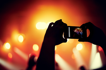 Image showing Hands, smartphone or image of band at concert, music event or audience with light in bokeh. Person, photography or picture on cellphone, technology or celebration with crowd at disco performance