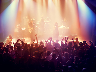 Image showing Concert, band and music with hands from people at dj, club and festival event at a stage with lights. Rock show, dance and party with excited crowd with rave, techno and entertainment at venue