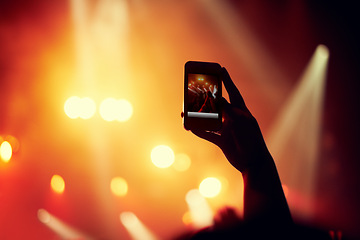 Image showing Hands, smartphone or image of performance at concert, music event or audience with flashlight in bokeh. Person, photography or online on cellphone, technology or celebration with crowd for live band