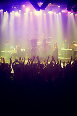 Image showing Concert, audience and stage with hands from fans at dj, band and festival event with lights and music. Rock show, dance and party with excited crowd with rave, techno and entertainment at venue