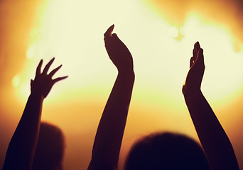 Image showing Concert, applause and hands of people in audience or crowd with energy for dance party at night. Music, light and event with group of fans at rock performance on stage for celebration festival