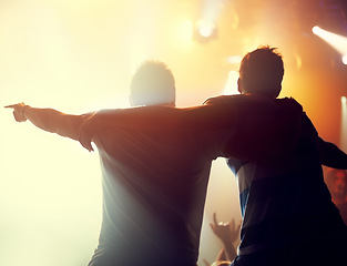 Image showing Night, concert and friends dance to music at festival, event of party on holiday and vacation. Rock, fans and people embrace in celebration at club disco, rave and audience with light from stage