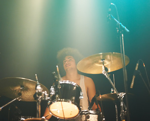 Image showing Man, drums and playing at concert in band for performance, show or party event at night. Male person, drummer or performer musician on base instrument for rock festival, audience or crowd of fans