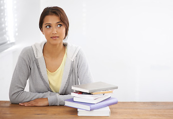 Image showing Woman, student or thinking with books by desk, idea or learning for research of assignment. Young person, indian and thought by notebook on scholarship, studies and planning for test study in college