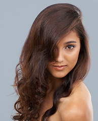 Image showing Portrait, beauty and curly hair of woman in salon at studio isolated on a grey background. Face, aesthetic and hairstyle of model in makeup cosmetics, hairdresser and treatment for care of skin glow