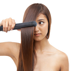 Image showing Beauty, straightener and young woman in studio for cosmetic, salon and hair care treatment. Flat iron tool, heat and confident female person with healthy hairstyle routine by white background.