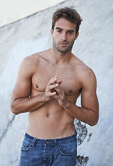 Image showing Man, portrait and fitness body with abs, stomach and wellness outdoor by a wall. Summer, workout and fashion of a male person from Brazil with strong arms, torso and topless with confidence and smirk