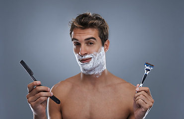 Image showing Man, portrait and shaving choice with cream in studio for razor, modern or retro grooming by grey background. Person, model and decision with beard, facial hair removal or product for cosmetic change