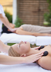 Image showing Women, health and massage with hot stones, wellness and peace with hands for shoulder at spa. People, comfort and zen for physical therapy by masseuse, body treatment and detox on bed at resort