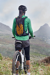 Image showing Woman, mountain bike and fitness in nature trail with vision, ready or idea on adventure with back. Girl, person and start with challenge, race or journey with bicycle on hill workout in Cape Town