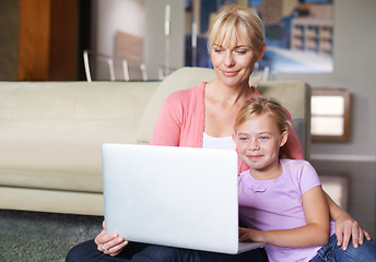 Image showing Mother, child and relax by laptop on living room floor, happy and stream subscription in apartment. Daughter, woman and smile on computer by online cartoon, technology and connected on couch in house