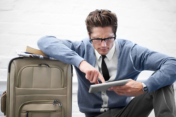 Image showing Business man, reading or baggage with tablet, floor and stress with app, flight or travel by wall background. Entrepreneur, person or touchscreen on social media, bag or check booking for immigration