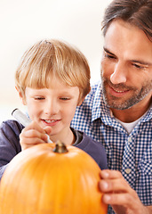 Image showing Child, father and drawing on pumpkin for halloween, craft and celebrate party at home. Happy boy kid, dad and family writing with pen marker on vegetable for holiday lantern, decoration or creativity